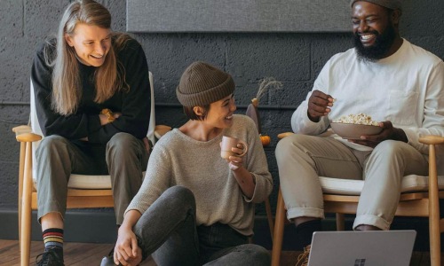 Refined spaces to match your style friends sit together around an open laptop
