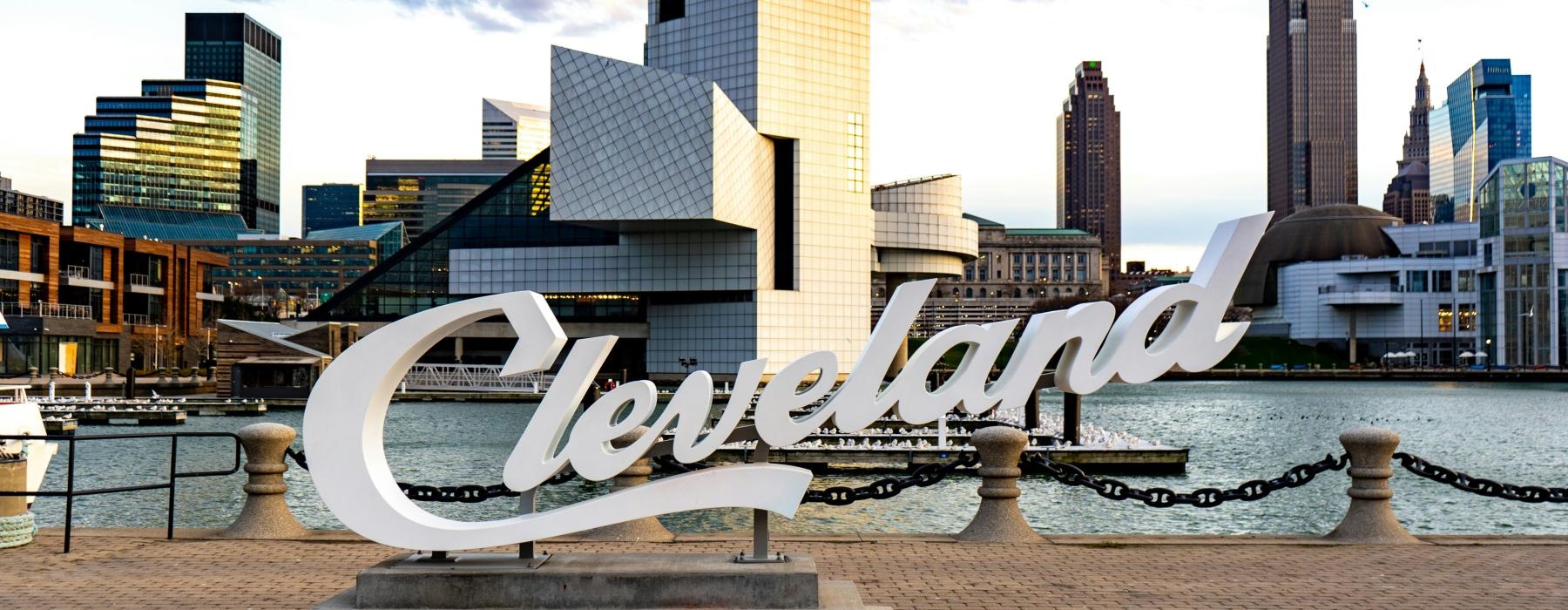 a large sculpture in front of a city