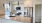 a kitchen with an island and white cabinets