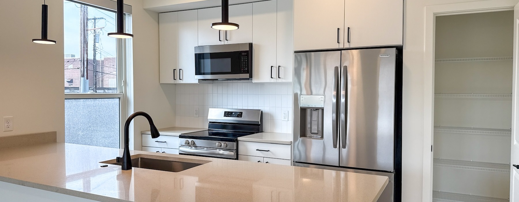 a kitchen with an island and white cabinets