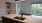 a kitchen and an empty living room with a laundry closet