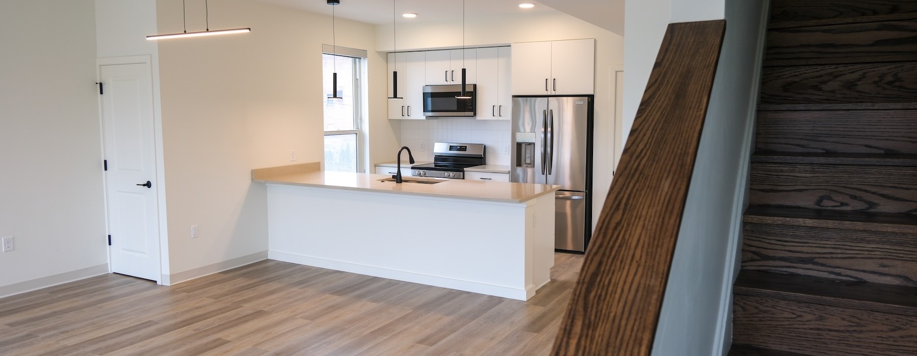 an empty kitchen and living room