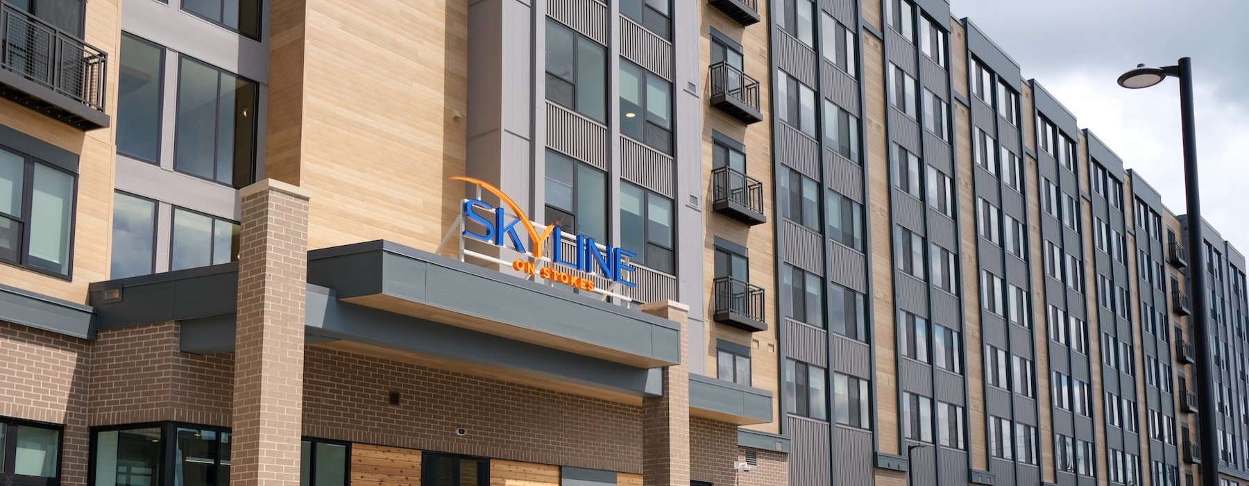 the entrance of a building with a large sign
