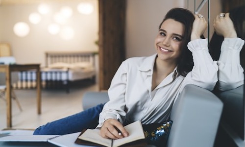 Smiling woman taking notes